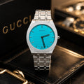 Gucci Men's | Silver Stainless Steel | Turquoise GG Dial - VogueHourGucci Men's | Silver Stainless Steel | Turquoise GG Dial